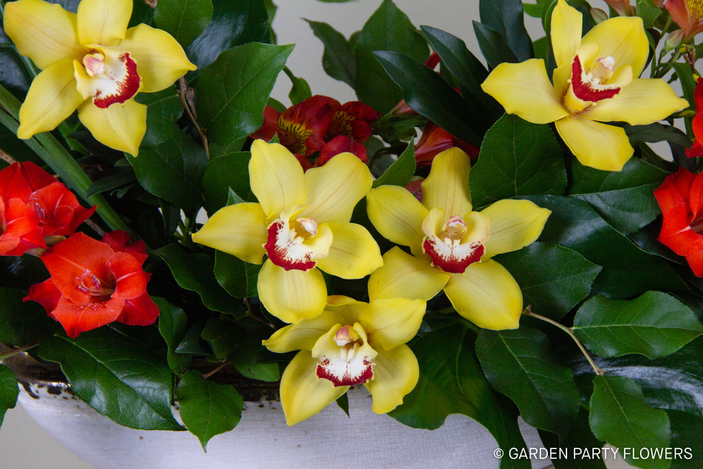 A lovely floral arrangement including gladiolas and cymbidium orchids for Lunar New Year.